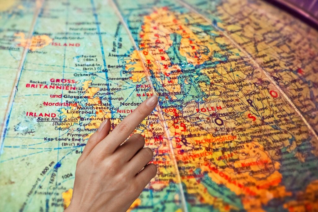 Finger pointing to a location on a map - trip planning