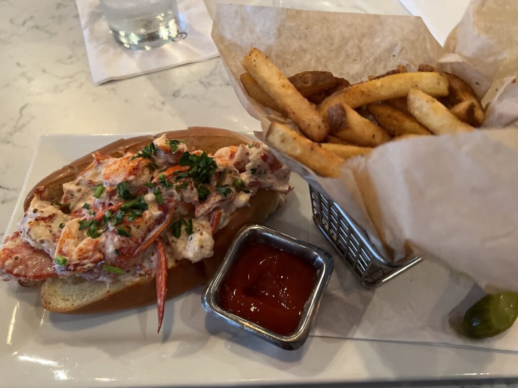 Lobster roll and french fries on a bar in a restaurant
