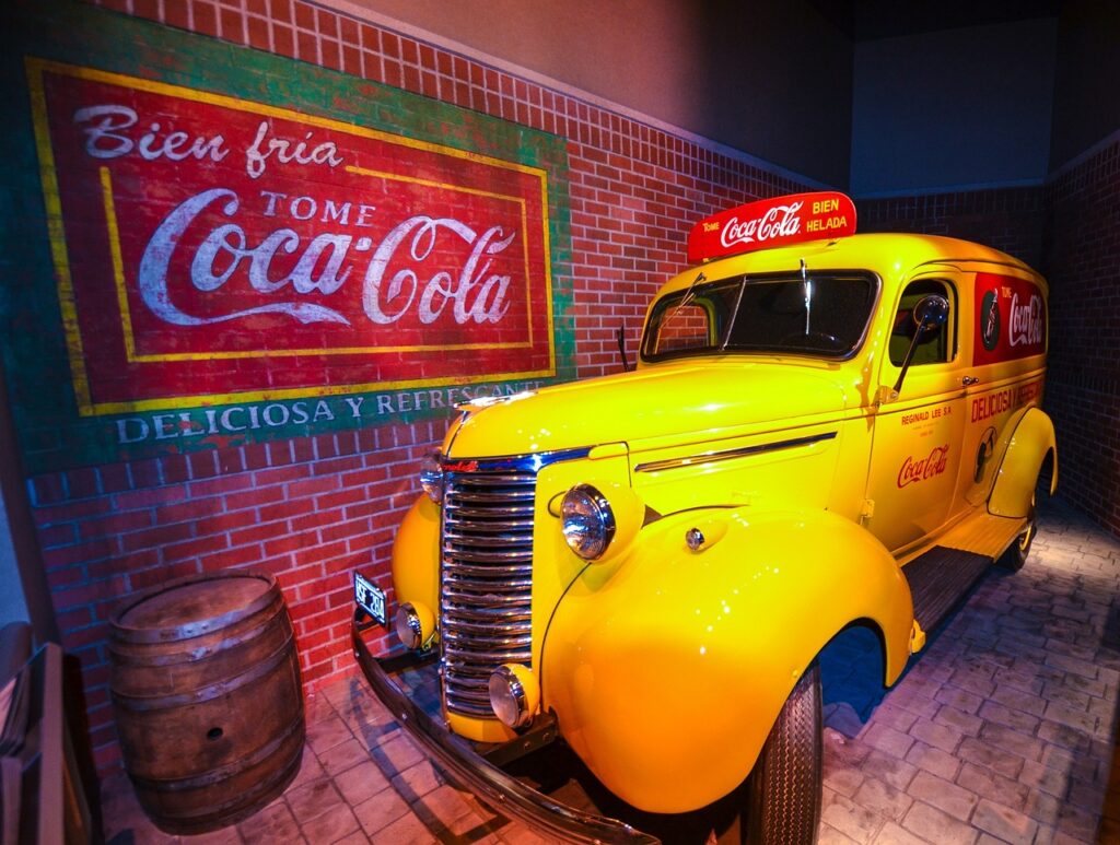 Coca Cola sign and yellow car.