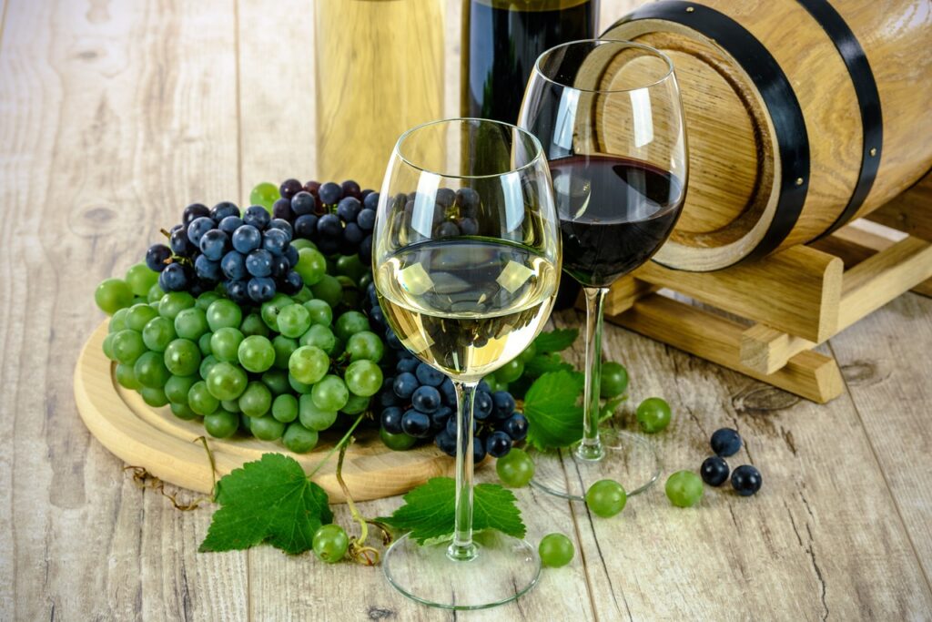 Two glasses of red & white wine with grapes. Featured at a bachelorette party in Colorado