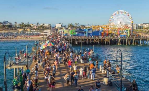 People milling about on the Santa Monica Pier in California. It is one of Santa Monica's top attractions