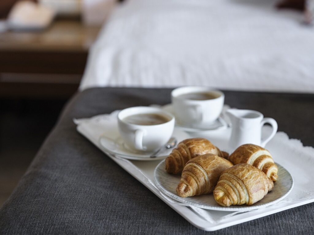 breakfast with coffee croissants being served at a luxury hotel