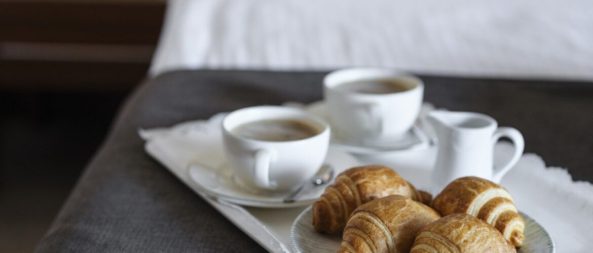 breakfast with coffee croissants being served at a luxury hotel