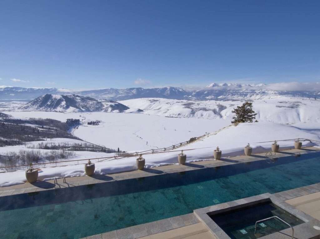 View of the snow covered mountains from the pool of the Amangani Hotel