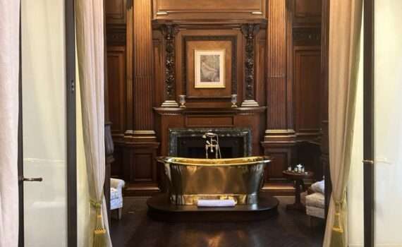 A gold free standing bathtub in the luxury suite at the Raffles in London