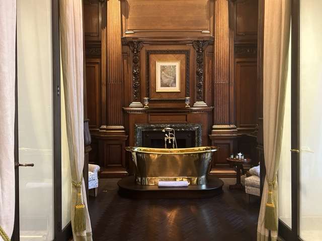 A gold free standing bathtub in the luxury suite at the Raffles in London