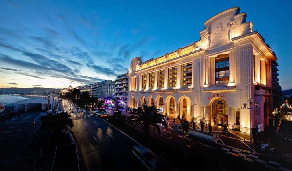 The entrance of the Hyatt Regency in Nice lit up at night