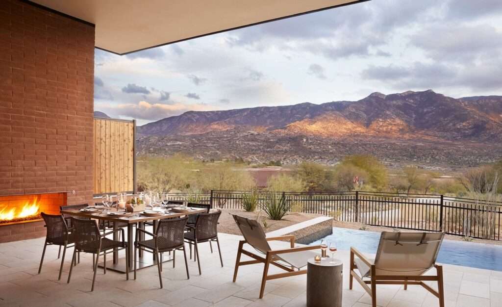 Outdoor dining at the Miraval Arizona Resort & Spa. Views of the mountains and a fireplace nearby.