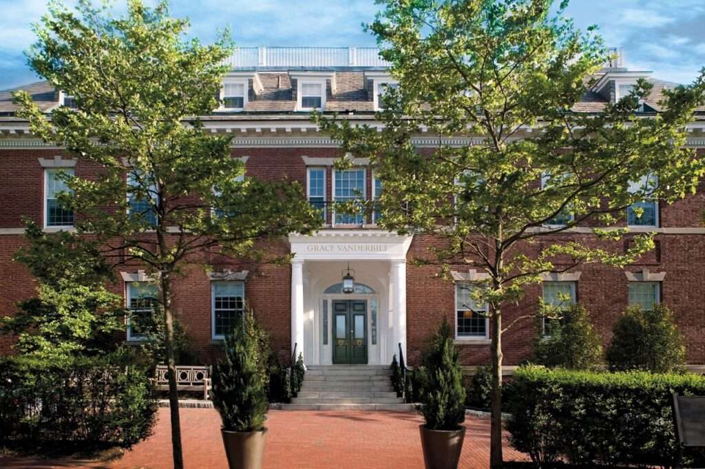 Entrance to the Vanderbilt Hotel in Newport Rhode Island- Brick front surrounded by trees
