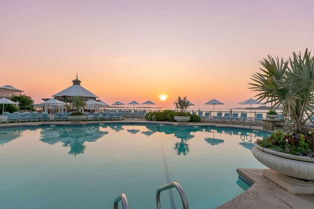 Wequasset Pool at Sunrise. Sun is rising over the ocean and pool - a luxury hotel in Massachusetts