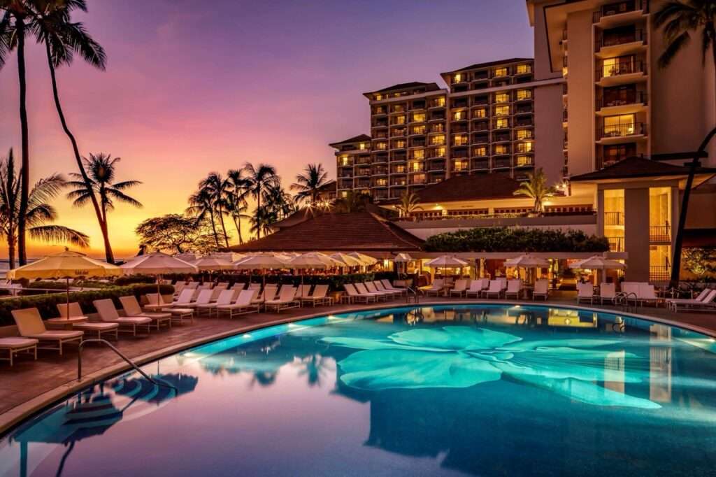 The outdoor pool at the Halekulani Hotel in Honolulu at sunset.