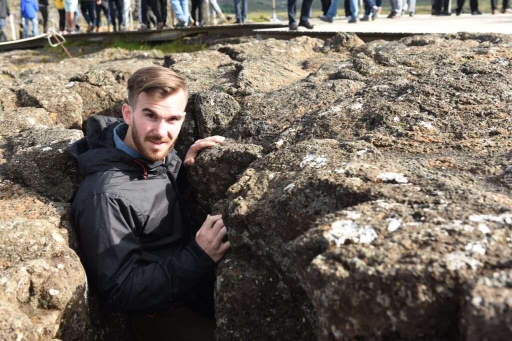 Man climbing between the tectonic plates in Iceland