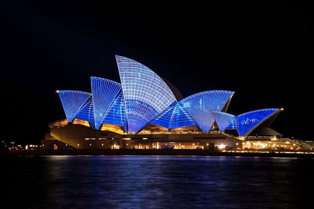 Opera house in Sydney Australia lit up at night - Sydney is considered one of the best girl trip destinations in the world