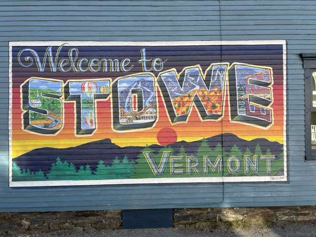 A mural painted on the side of a building in the center of Stowe Vt. Reads Welcome to Stowe Vermonth
