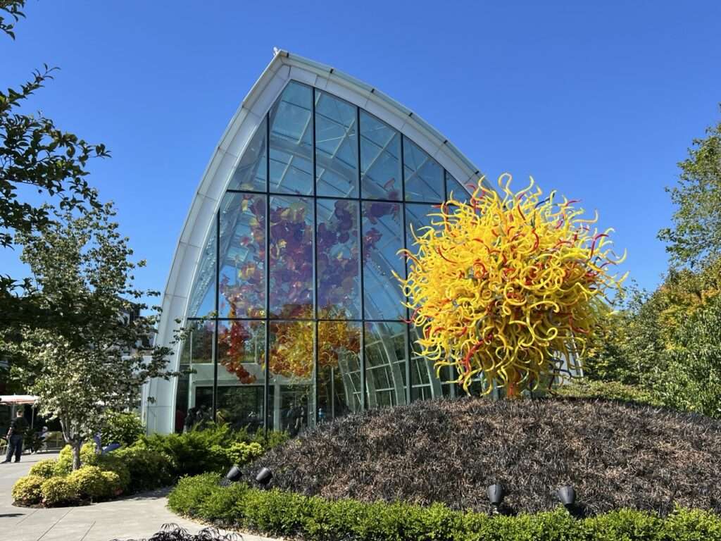 View of the glass greenhouse and sculptures from Chihuly Gardens