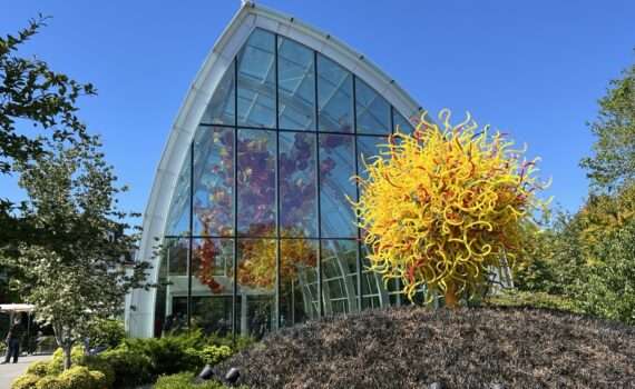 View of the glass greenhouse and sculptures from Chihuly Gardens