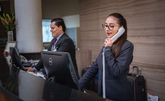 Hotel Concierges - two concierges on the phone - the etiquette for tipping them