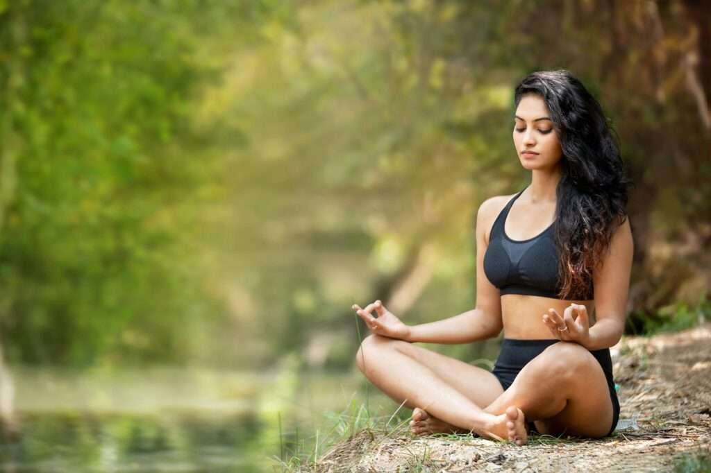 A woman practicing yoga on a wellness retreat experience