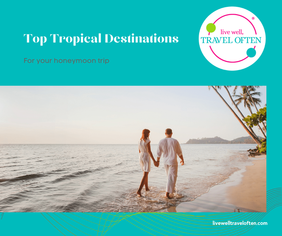 Top Tropical Honeymoon Destinations - a couple holding hands walking on a beach