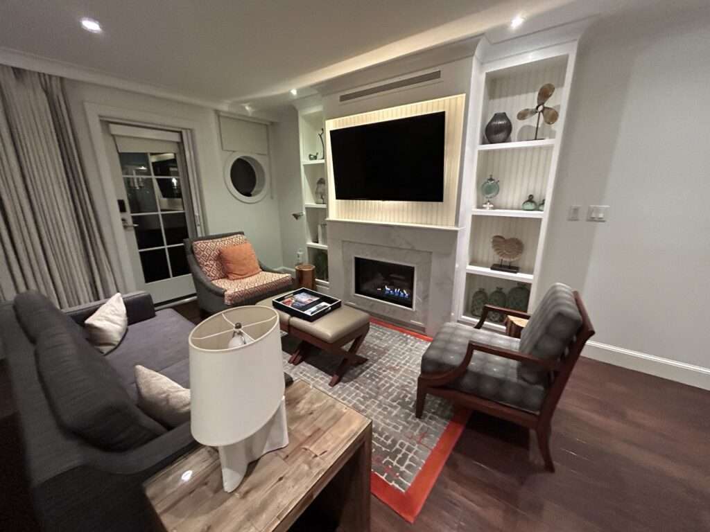 Suite living room at Inn By the Sea in Maine with a fireplace