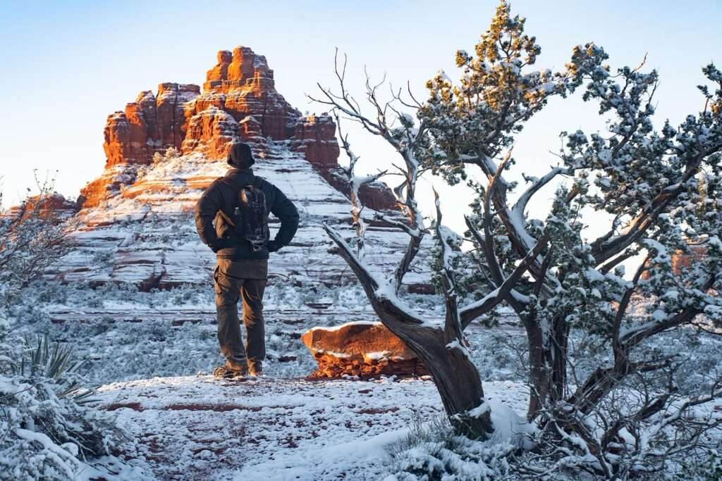 A hiker in Sedona - trail is covered in snow - Adventure in Arizona