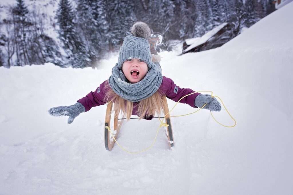 Child Sledding in Snow