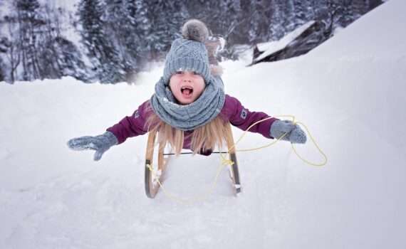 Child Sledding in Snow